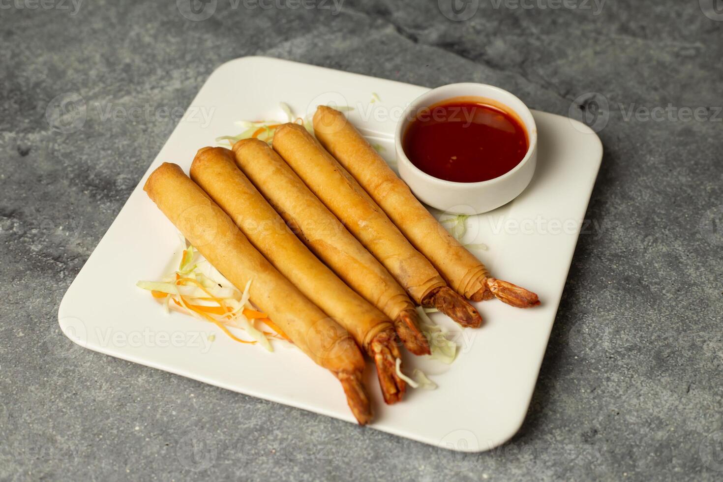 Deep fried Prawn Spring Roll with chilli sauce served in dish isolated isolated on background top view of bangladesh food photo