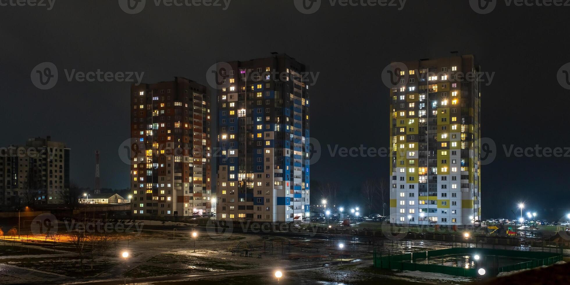 with light in windows of multistory buildings at night. life in a big city. Serenade of light photo