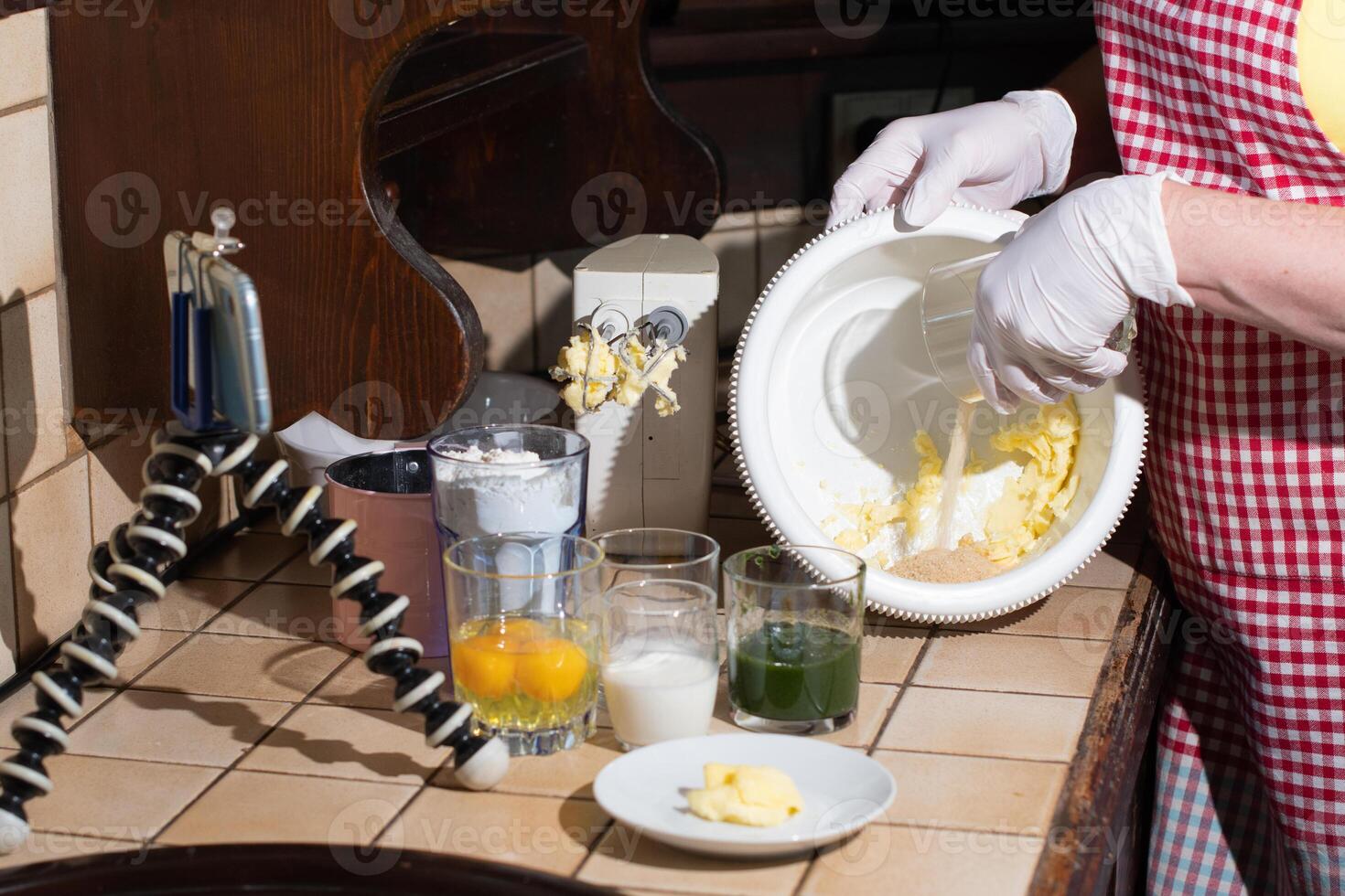 woman cooking spinach muffin step by step, pouring sugar into a bowl photo