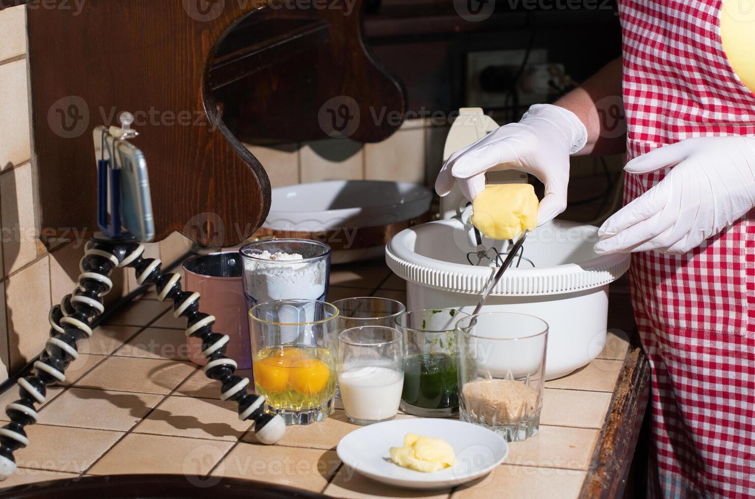 a woman prepares spinach muffins step by step, add butter to dough photo