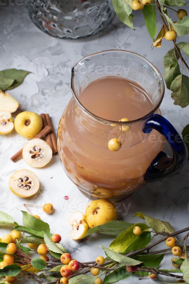 Assorted compote of apples and Japanese quince in a jug, delicious vitamin drink, chaenomeles photo