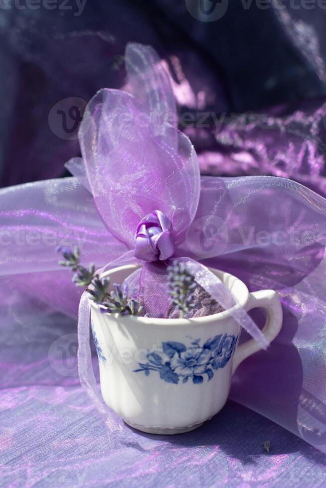 Lilac lavender sachets in vintage cup, chiffon bag for aromatherapy,still life photo