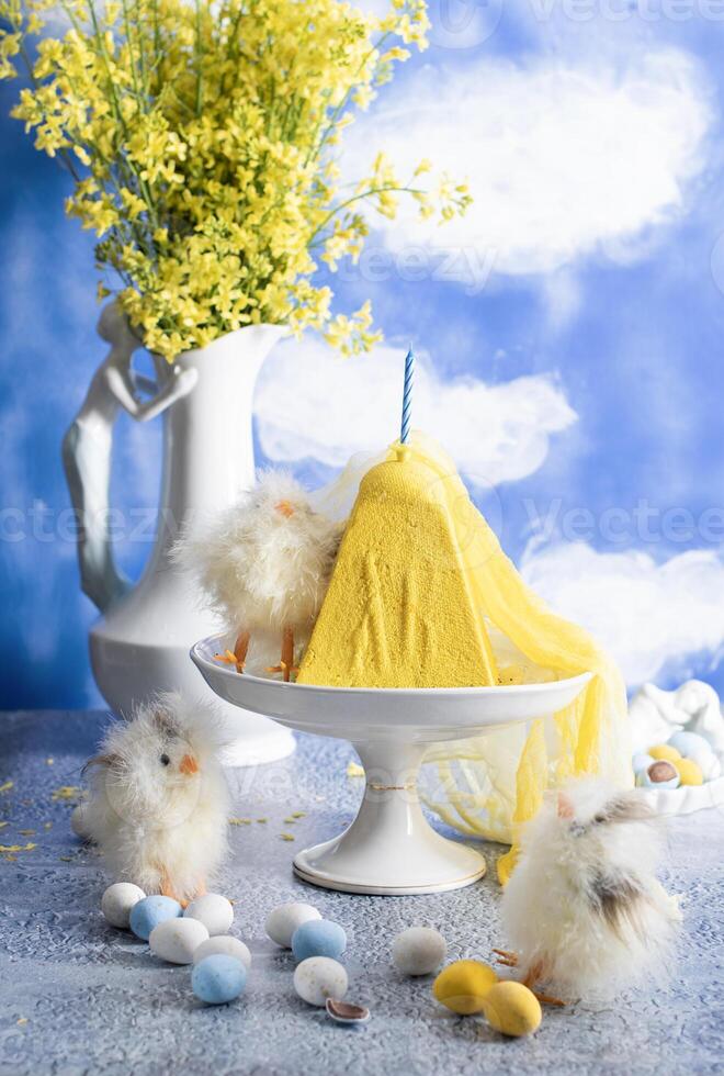 Traditional Easter Orthodox curd cake with yellow flowers against a blue sky photo