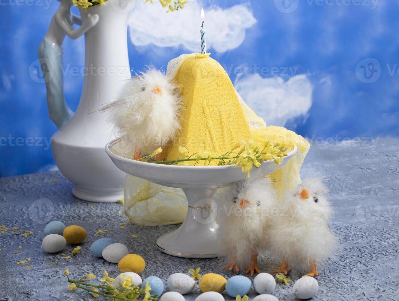 Traditional Easter Orthodox curd cake with yellow flowers against a blue sky photo