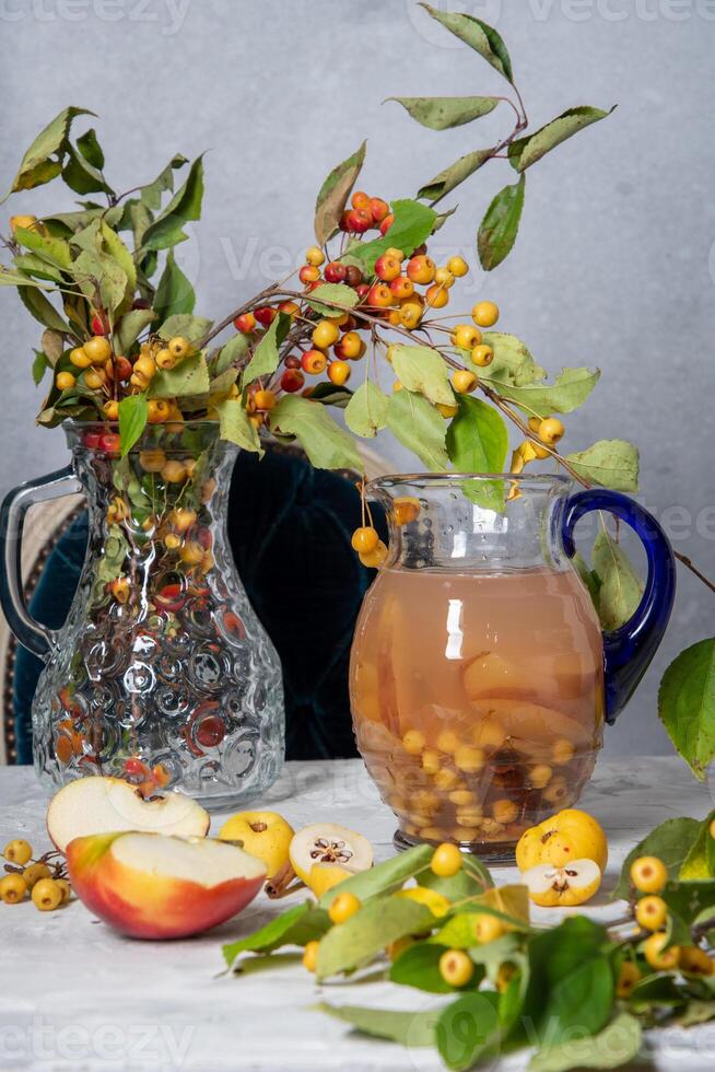 Assorted compote of apples and Japanese quince in a jug, delicious vitamin drink, chaenomeles photo