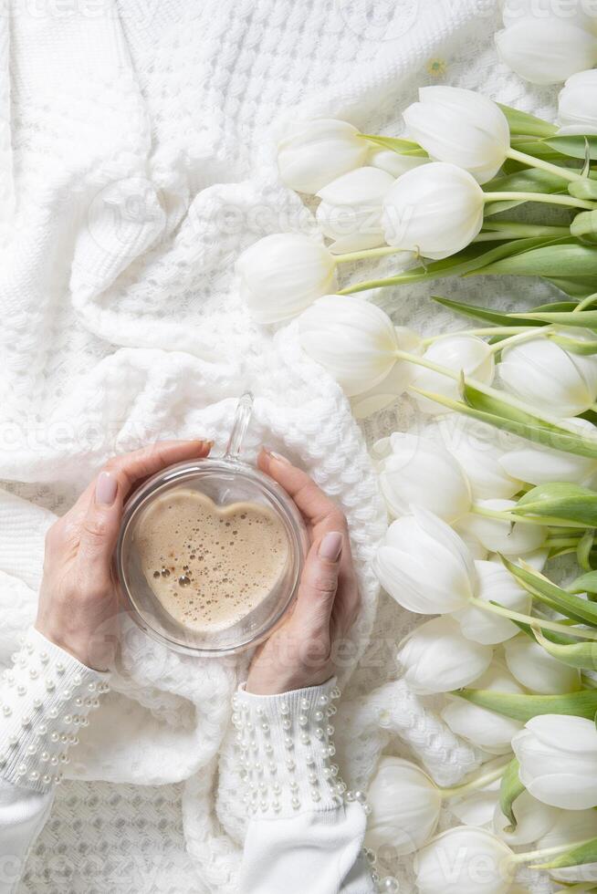 hands of two women holding a heart-shaped cup, female friendship, photo