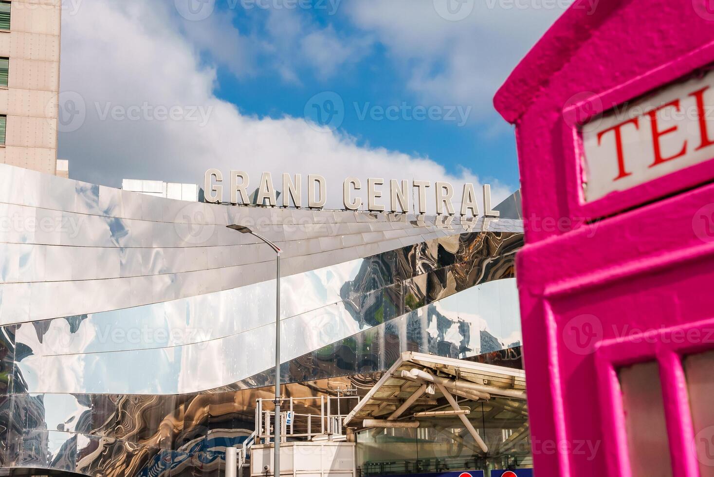 Grand Central in Birmingham Reflections Beside a Pink Telephone Box. photo