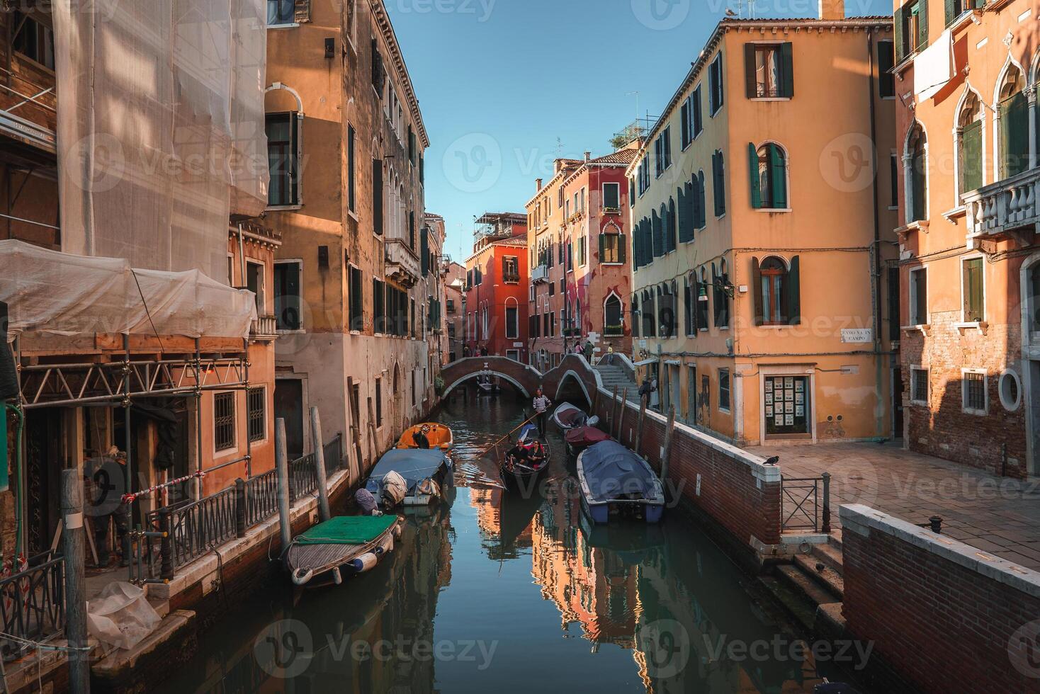 Scenic Narrow Canal in Venice, Italy with Traditional Architecture and Gondolas photo