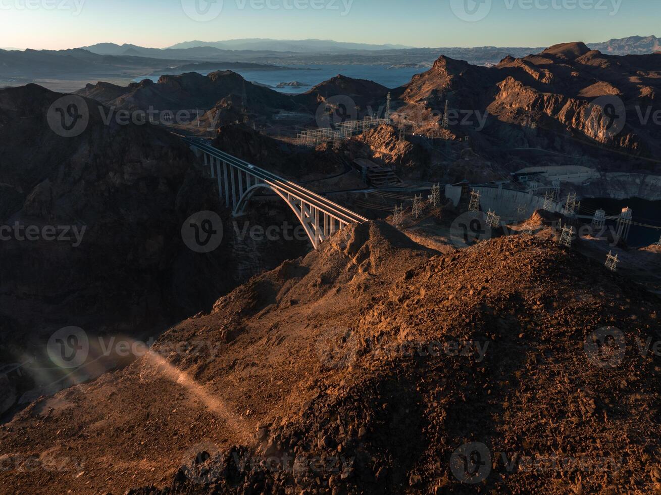 Hoover Dam on the Colorado River straddling Nevada and Arizona at dawn from above. photo