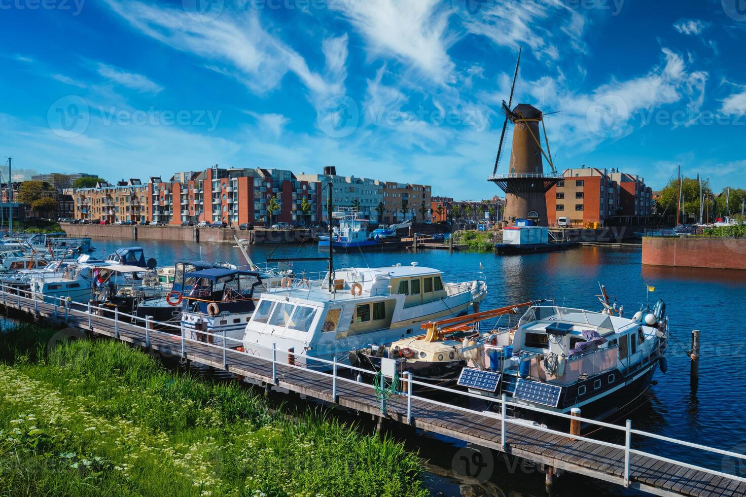 View of the harbour of Delfshaven and the old grain mill De Destilleerketel. Rotterdam, Netherlands photo