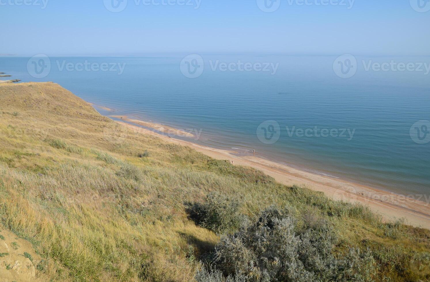 The hilly coast near the Sea of Azov. Clay rocks, a cliff on the shore photo