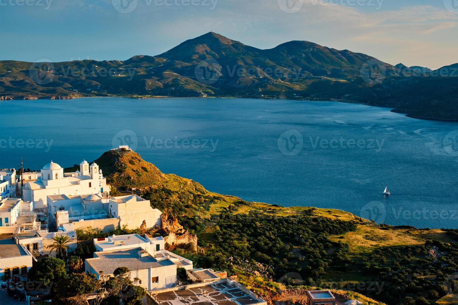 View of Plaka village on Milos island on sunset in Greece photo