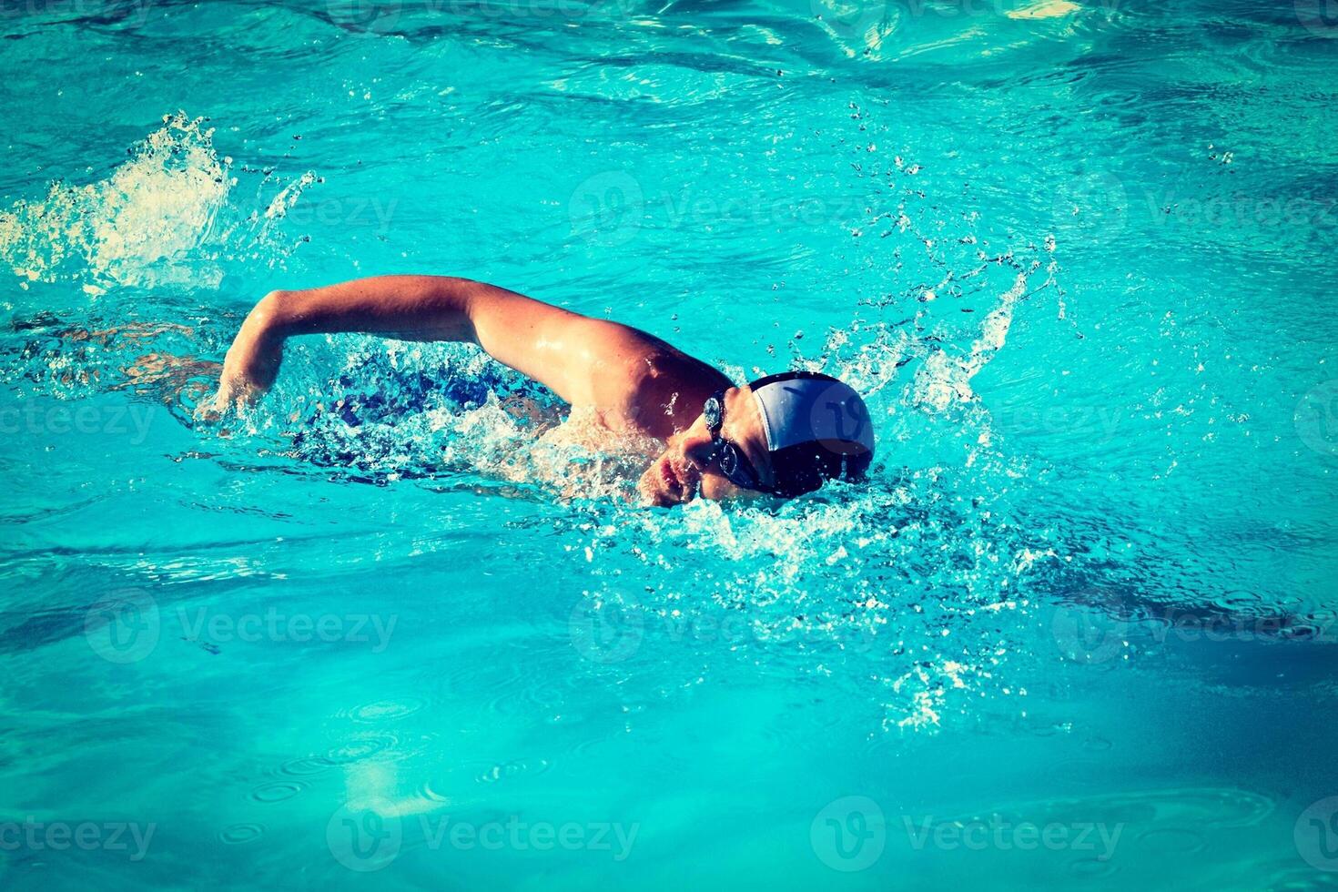 Swimming man swimmer in pool photo