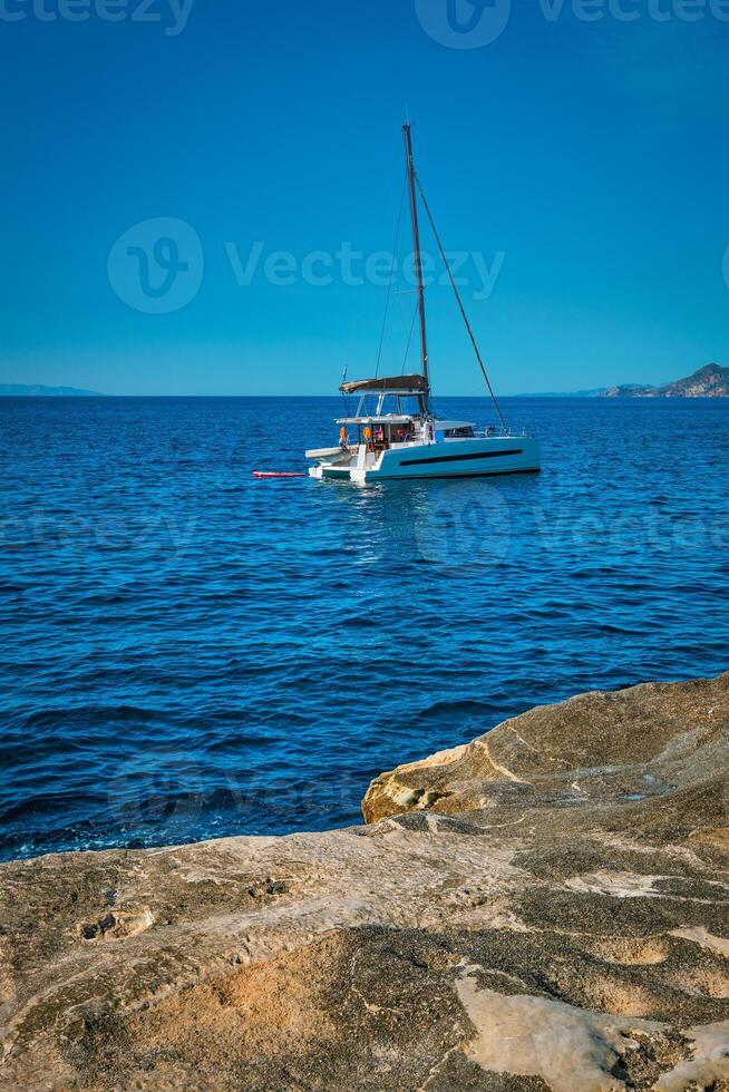 Yacht boat at Sarakiniko Beach in Aegean sea, Milos island , Greece photo