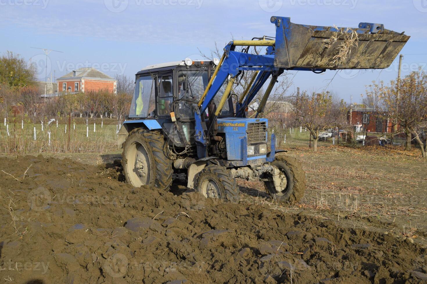 Tractor plowing the garden. Plowing the soil in the garden photo