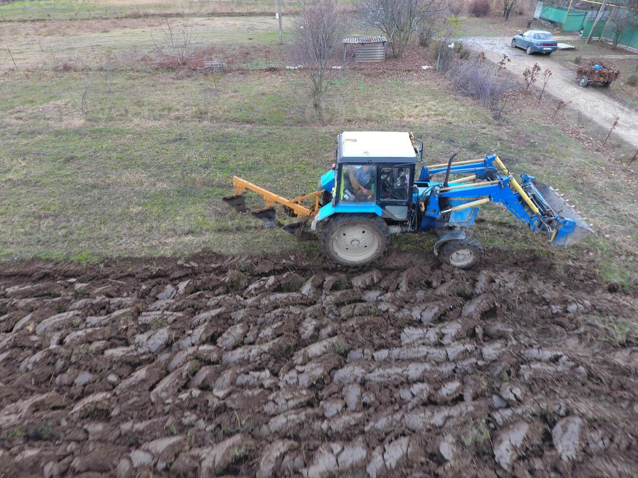 Tractor plowing the garden. Plowing the soil in the garden photo
