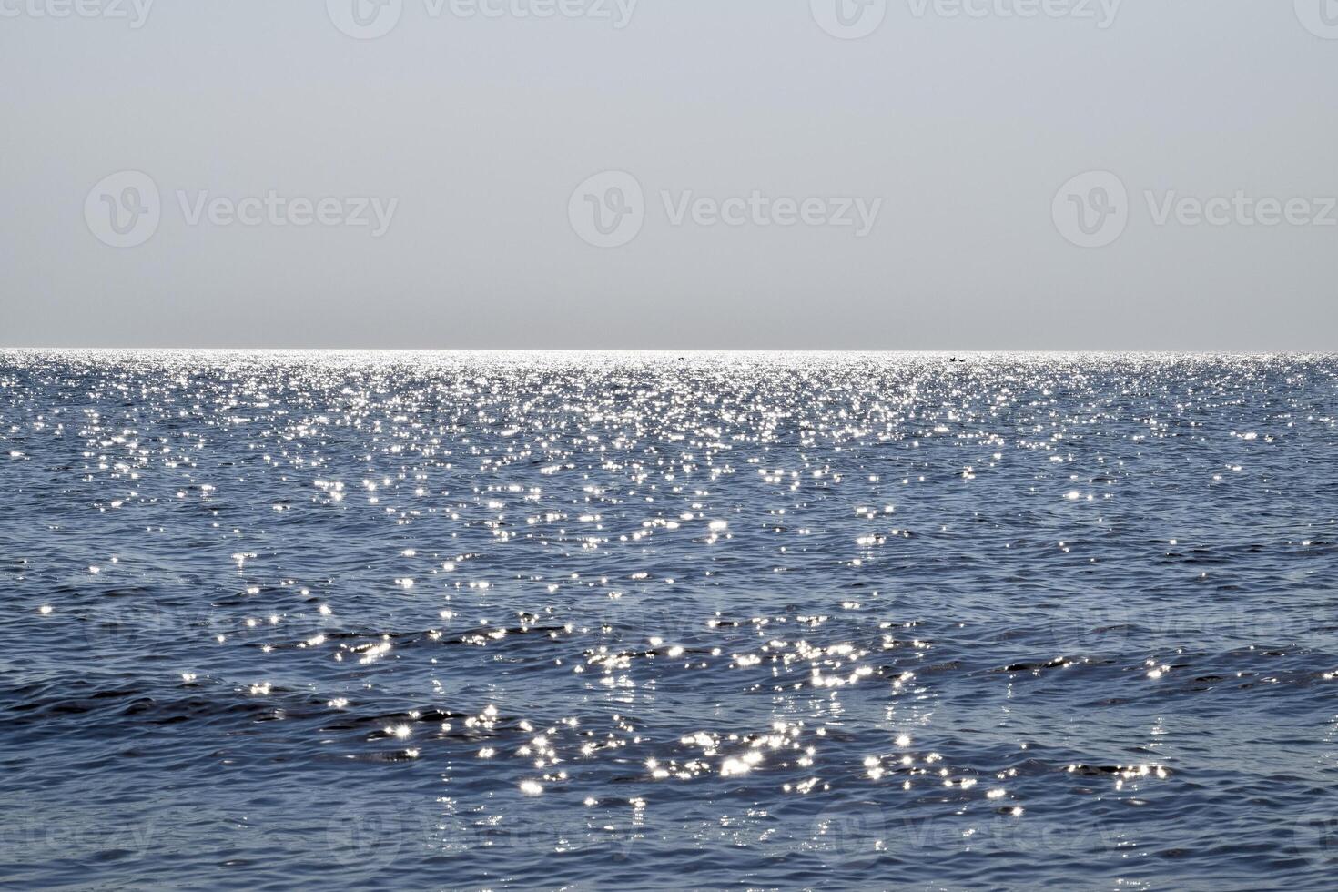 Sea line of the horizon. Sea and sky. The waves and glare of the sun are reflected from the waves of the sea. Seascape. photo