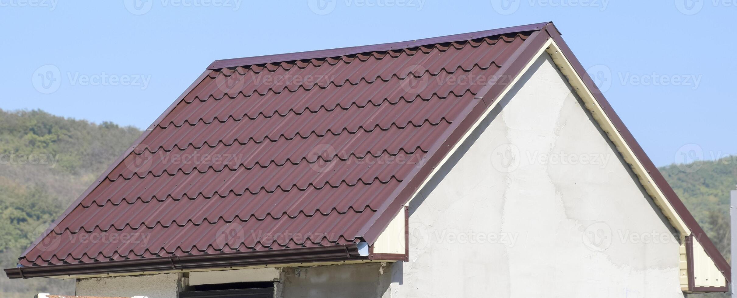 The roof of corrugated sheet. Brown corrugated metal profile roof. photo