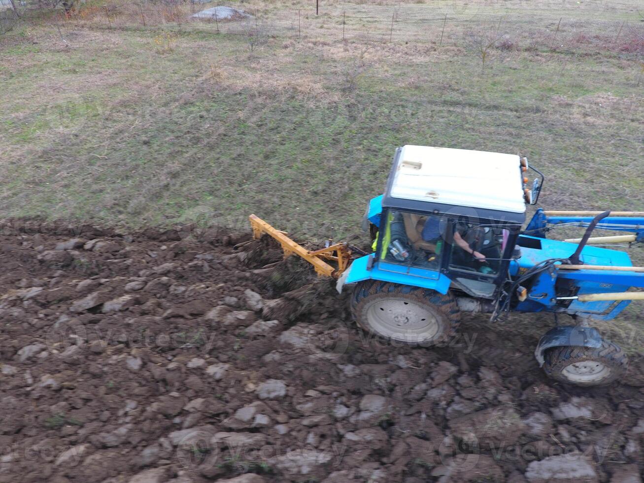 Tractor plowing the garden. Plowing the soil in the garden photo