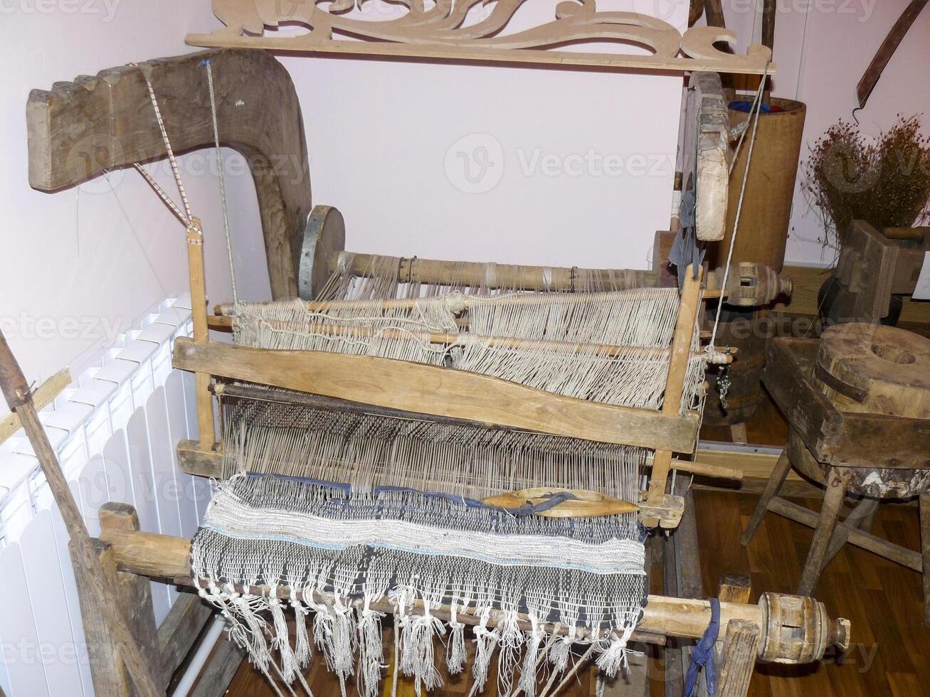 Ancient wooden loom. Ancient textile equipment. photo