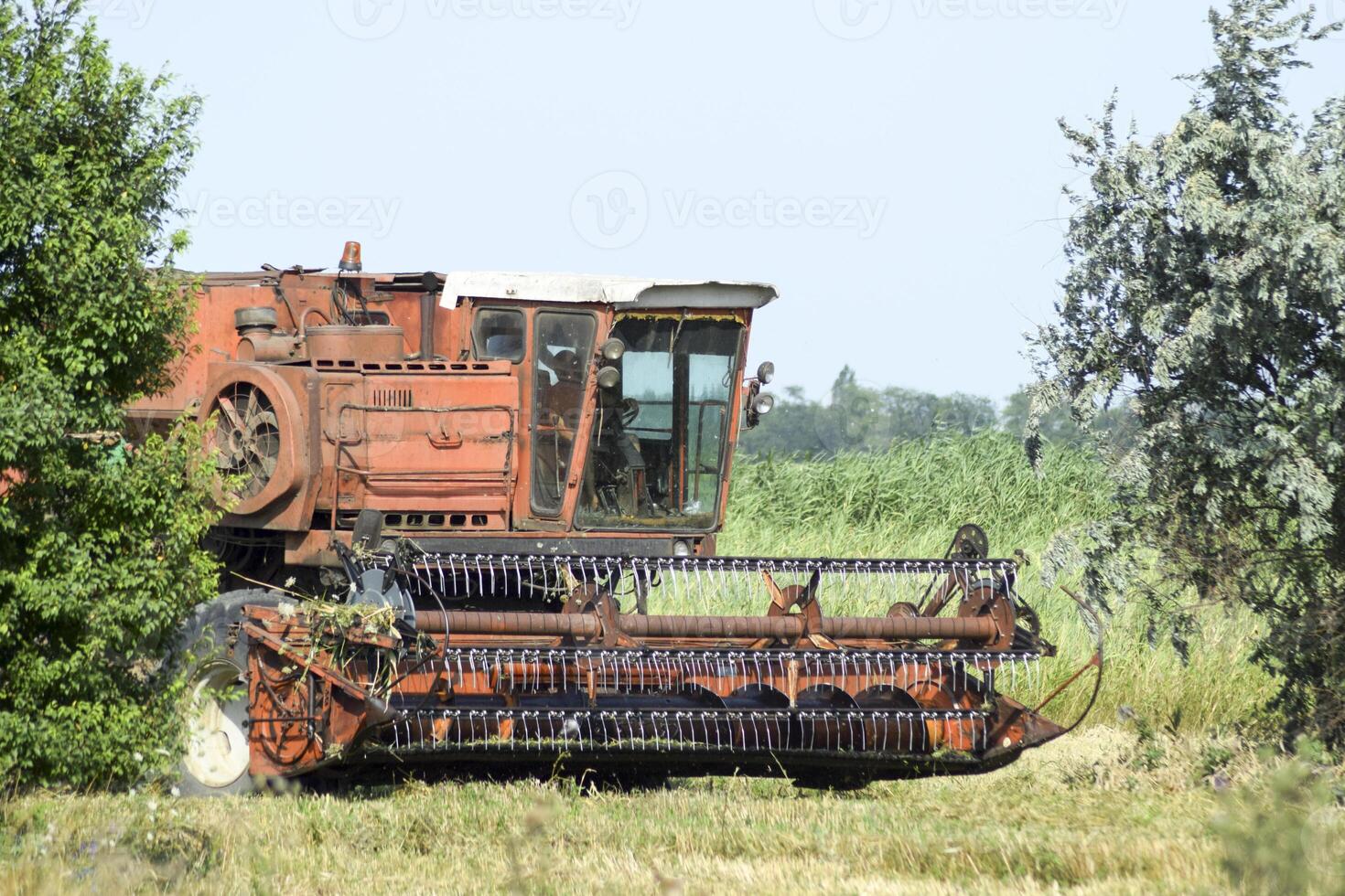 Old rusty combine harvester. photo