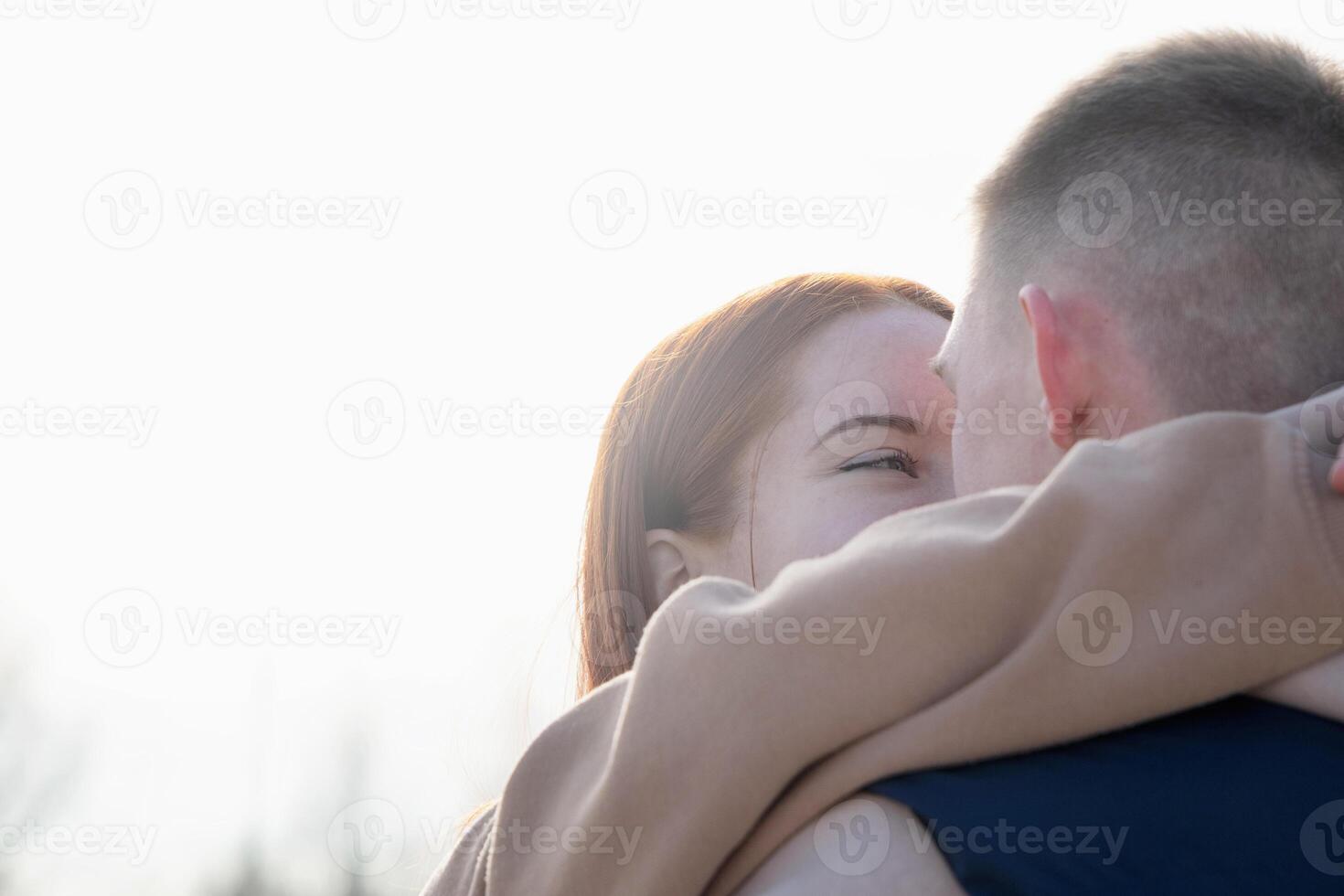 cheerful romantic couple dating and hugging outdoors, sky background photo