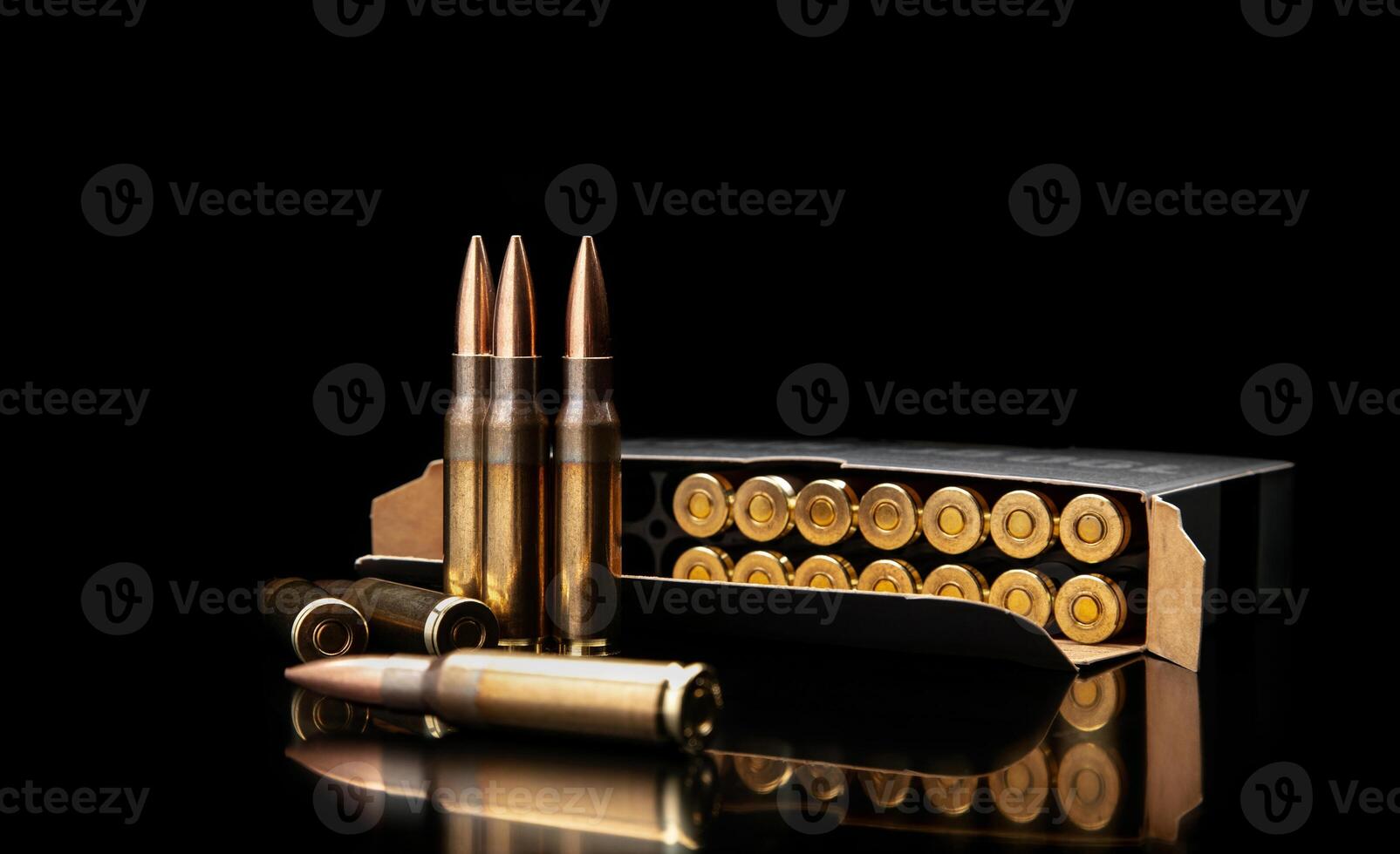 Bullet isolated on black background with reflexion. Rifle bullets close-up on black back. Cartridges for rifle and carbine on a black. photo