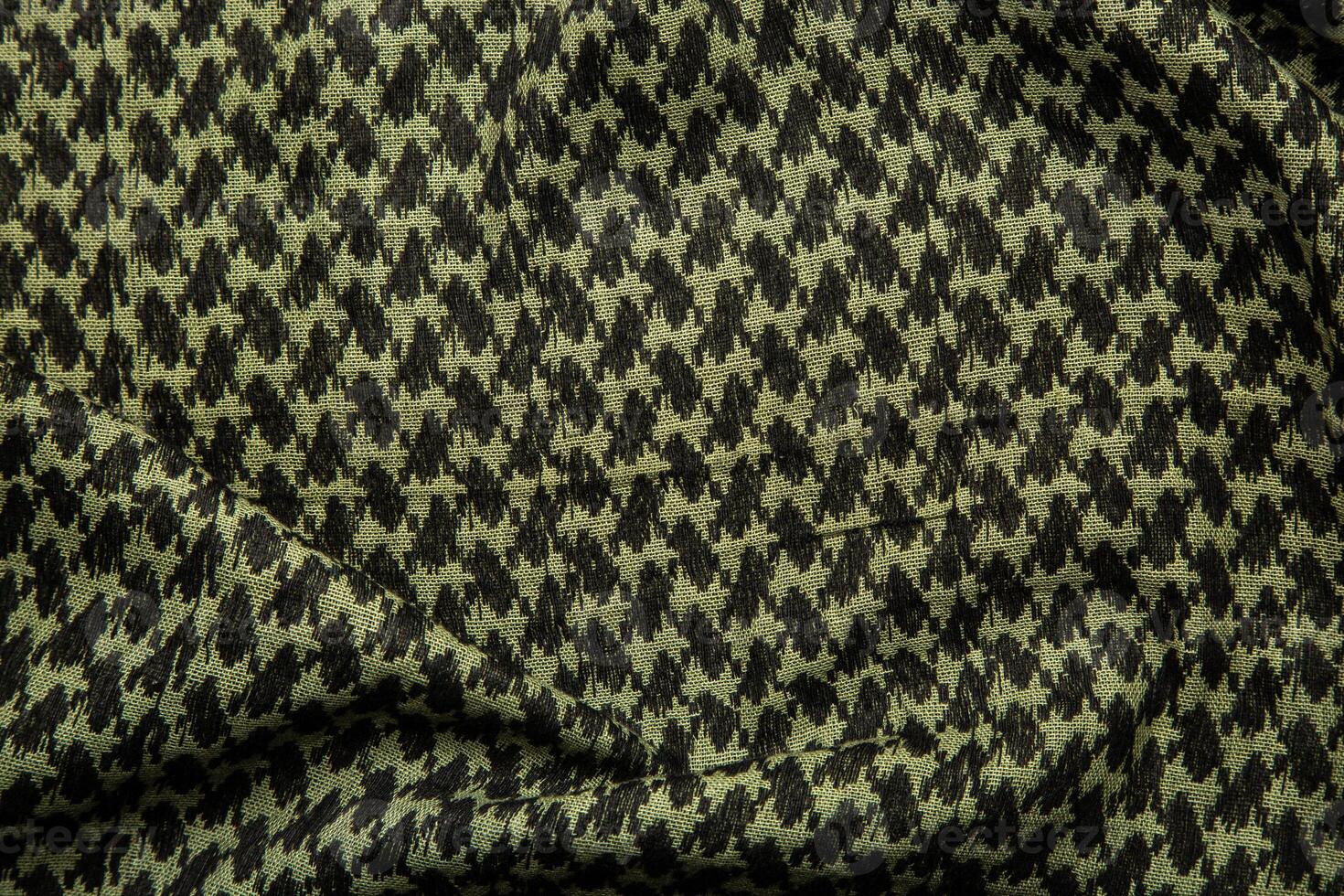 Keffieh scarf. The texture of the cotton traditional symbolic arabian scarf. Khaki back. photo