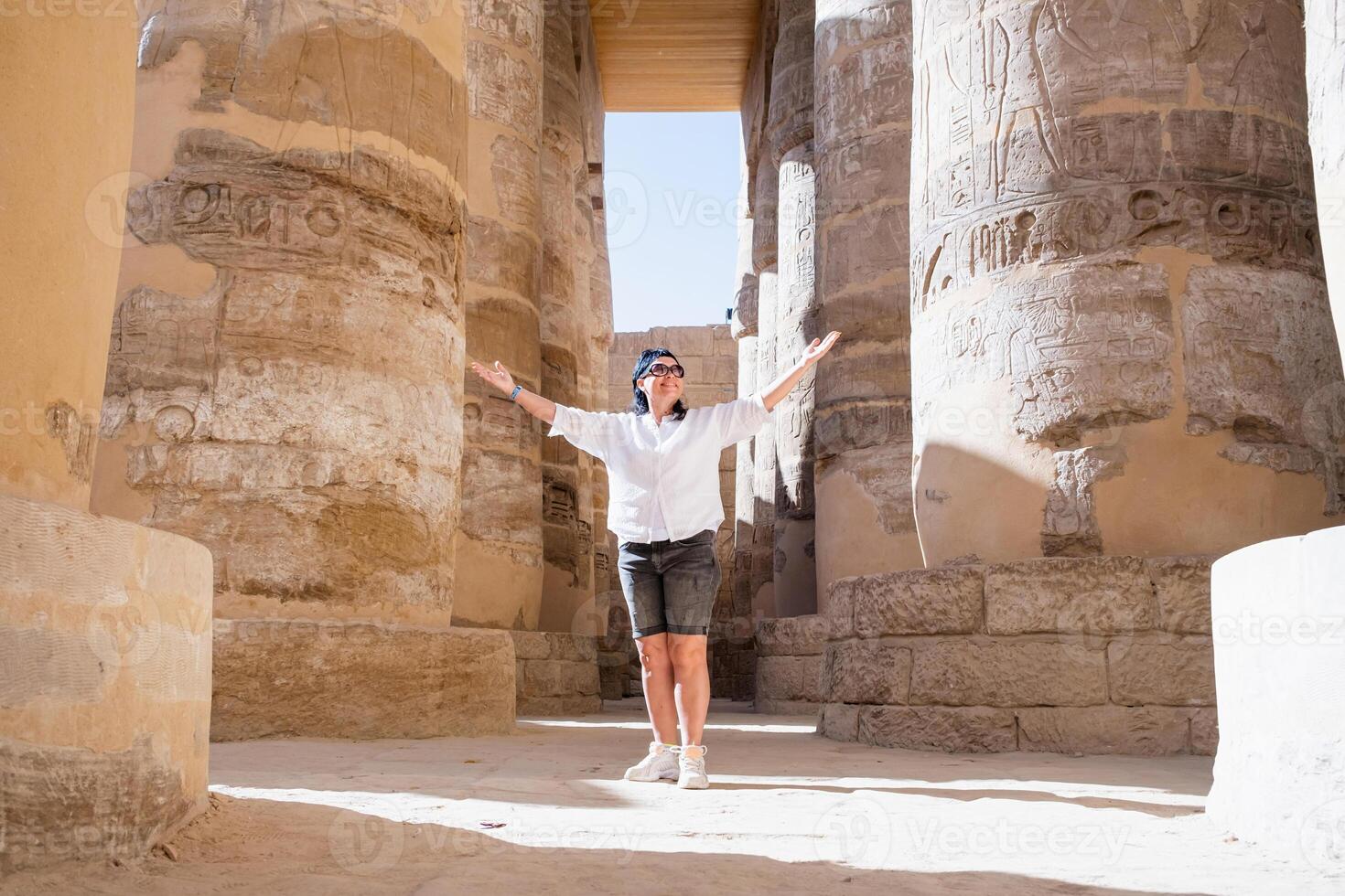 Woman traveler explores the ruins of the ancient Karnak temple in the city of Luxor in Egypt. photo