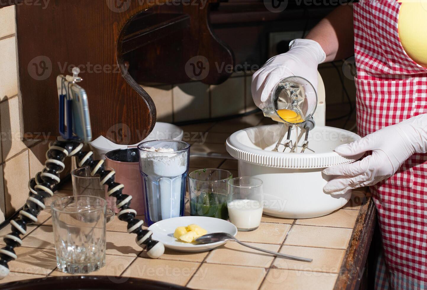 a woman prepares spinach muffins step by step, adds an egg yolk to the dough photo