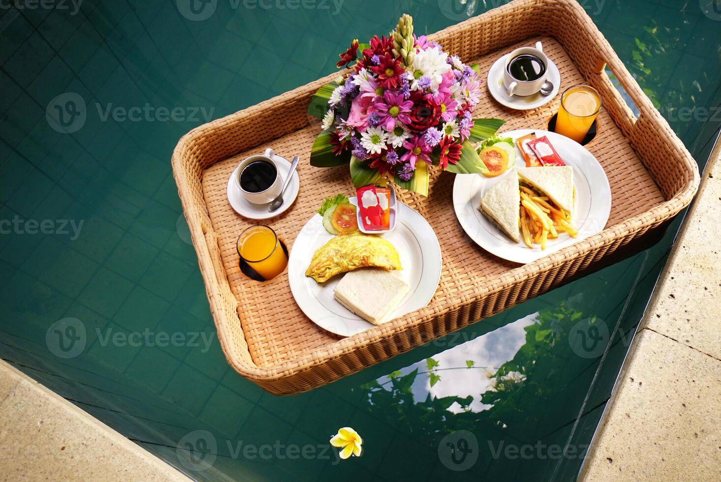 Set of floating breakfast tray in swimming pool. Breakfast in swimming pool, floating breakfast set in tray photo
