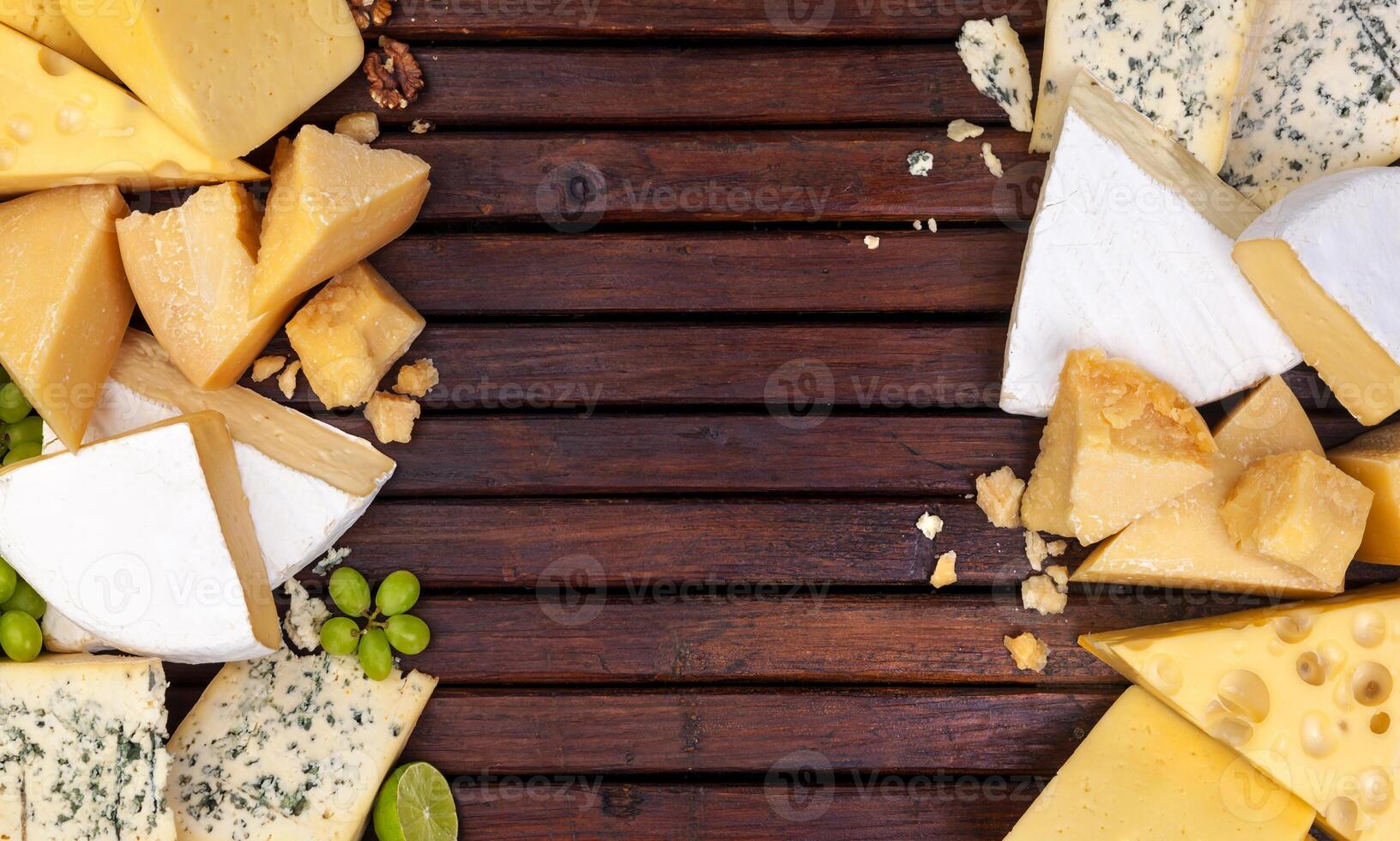 Different cheeses on wooden table photo