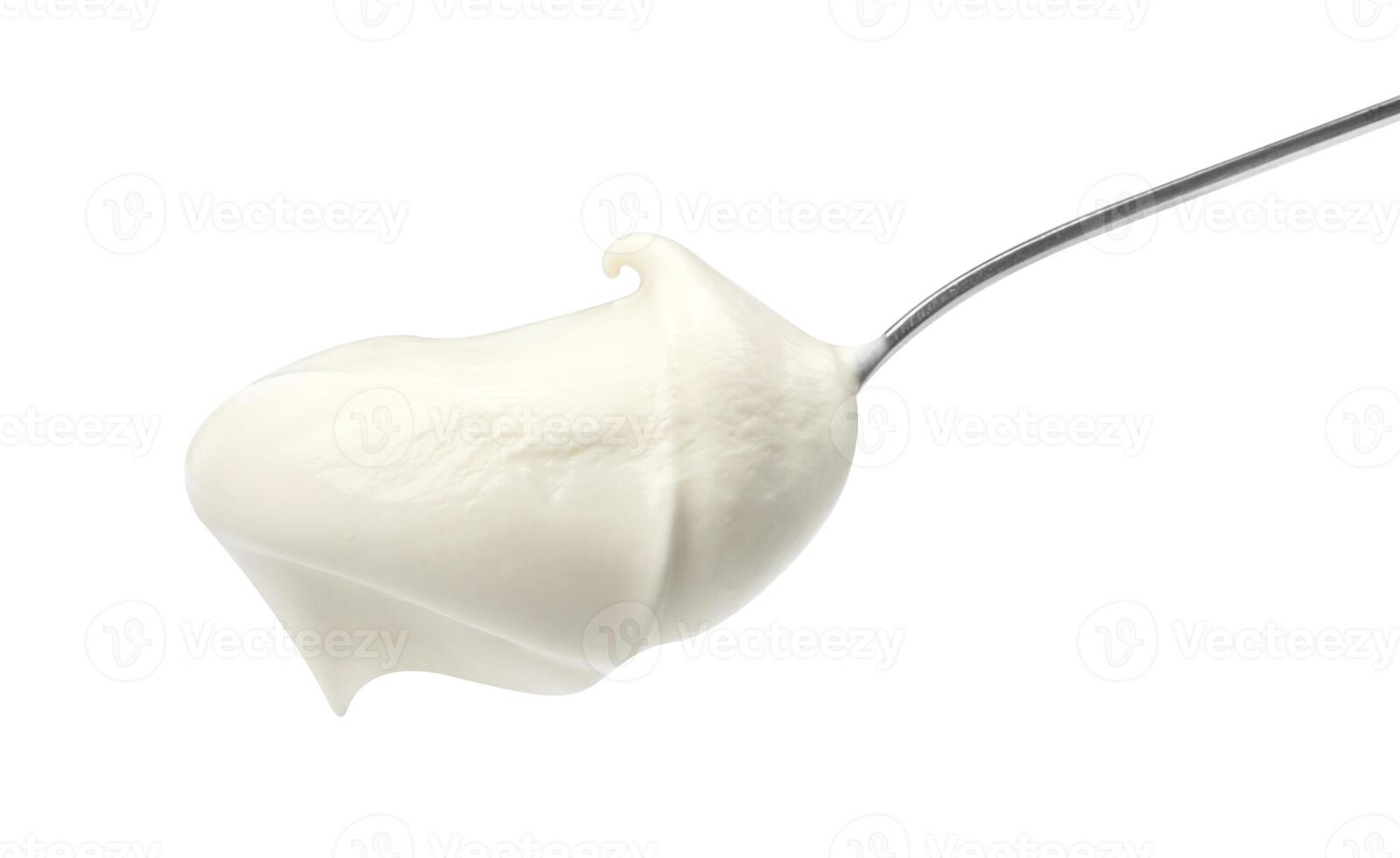 Sour cream in spoon isolated on white background photo