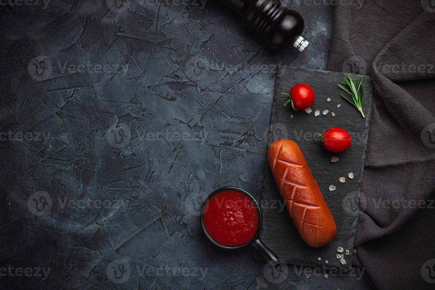 Grilled barbecue sausages with rosemary and spices. Top view. Free space for your text. photo