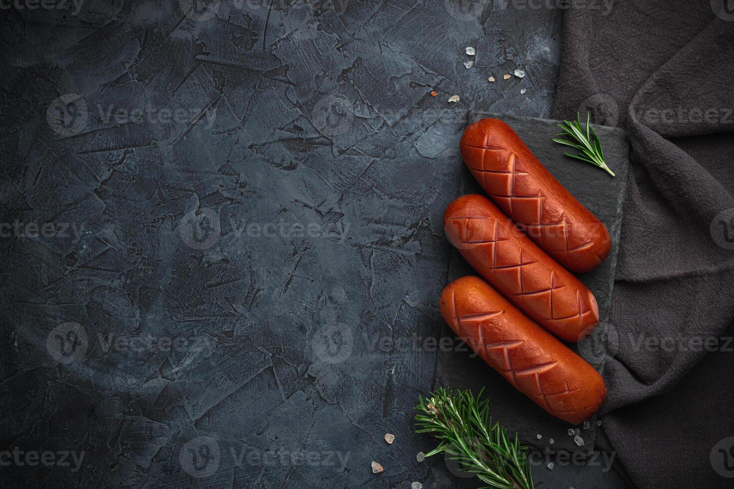Grilled barbecue sausages with rosemary and spices. Top view. Free space for your text. photo