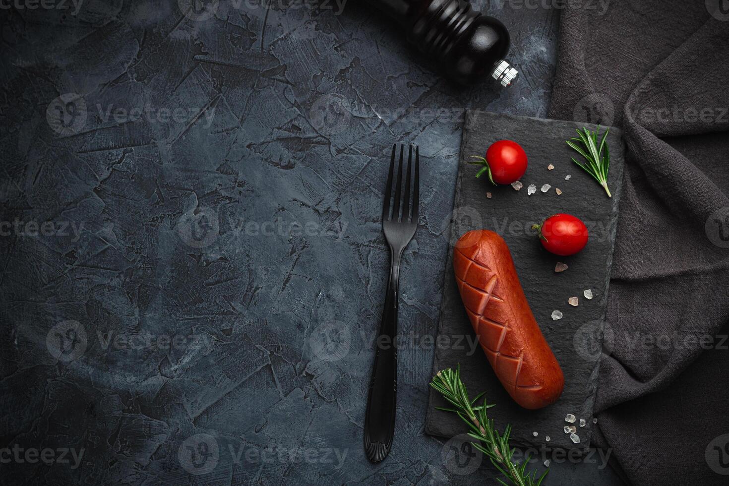Grilled barbecue sausages with rosemary and spices. Top view. Free space for your text. photo