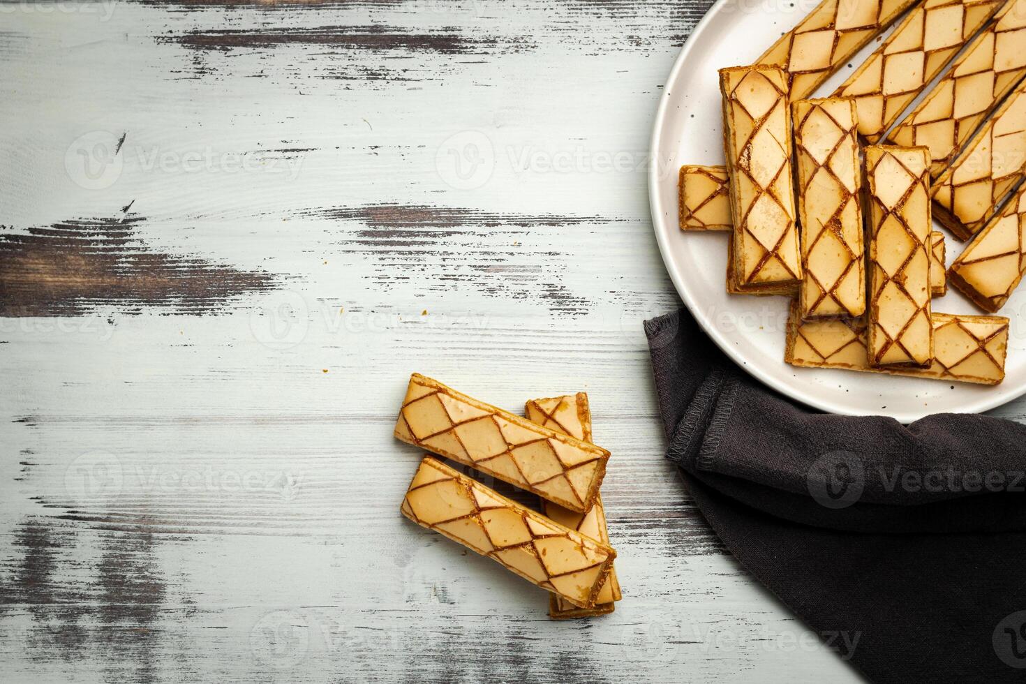 Sfogliatine, an Italian puff pastry with glaze on a plate on white background, top view photo