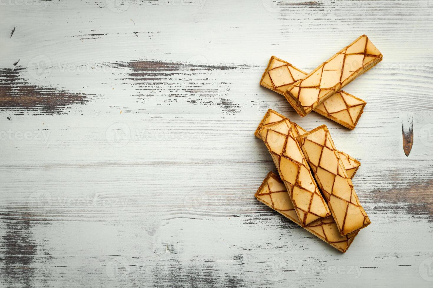 Sfogliatine, an Italian puff pastry with glaze on a plate on white background, top view photo