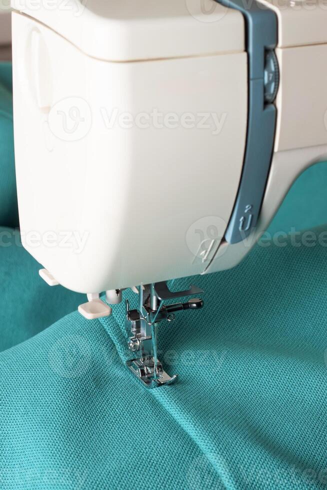 Modern sewing machine and turquoise fabric photo