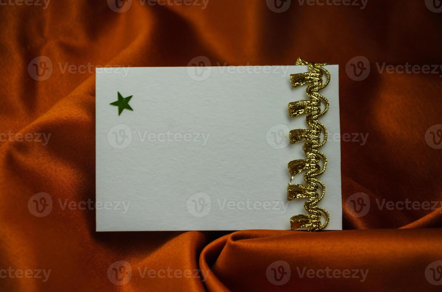 Textured brown background with writing card with gold decoration, shiny stars scattered around. High quality photo