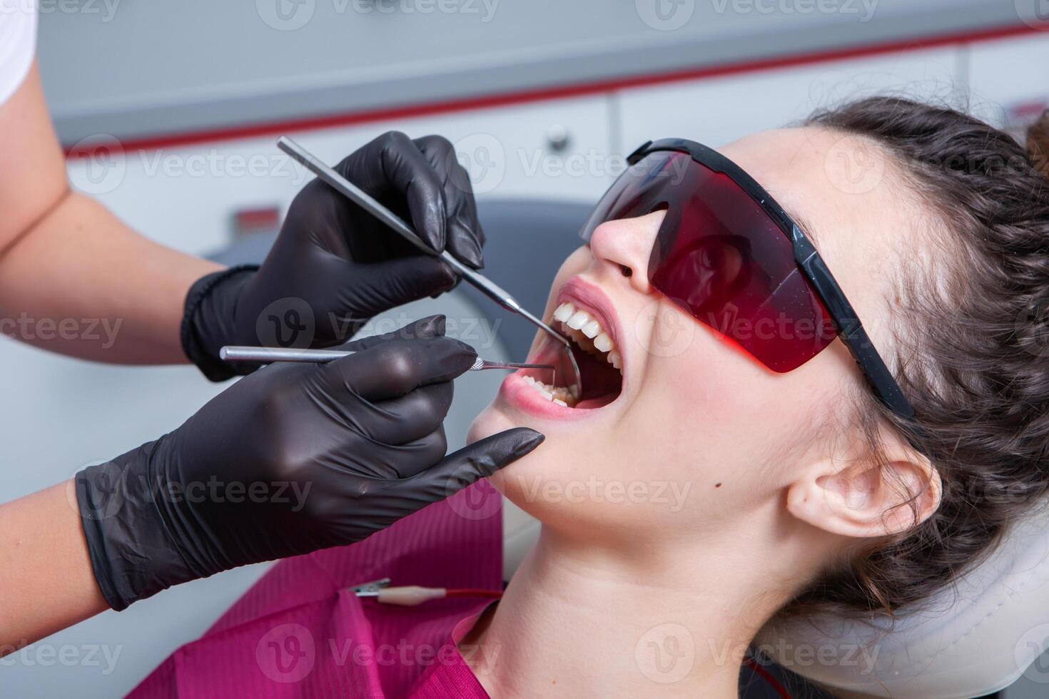 Woman having dental examination in stomatology clinic Treatment of caries, modern medicine. photo