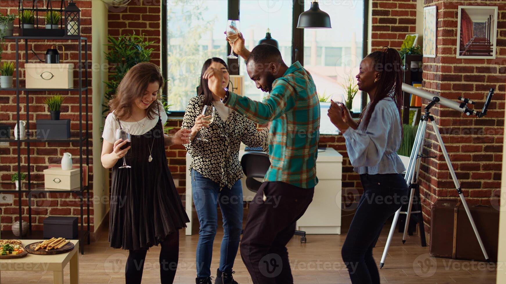 Multiracial school colleagues organizing apartment party, enthusiastically dancing to electronic music. Smiling friends enjoying time spent together, busting into dynamic dance moves photo