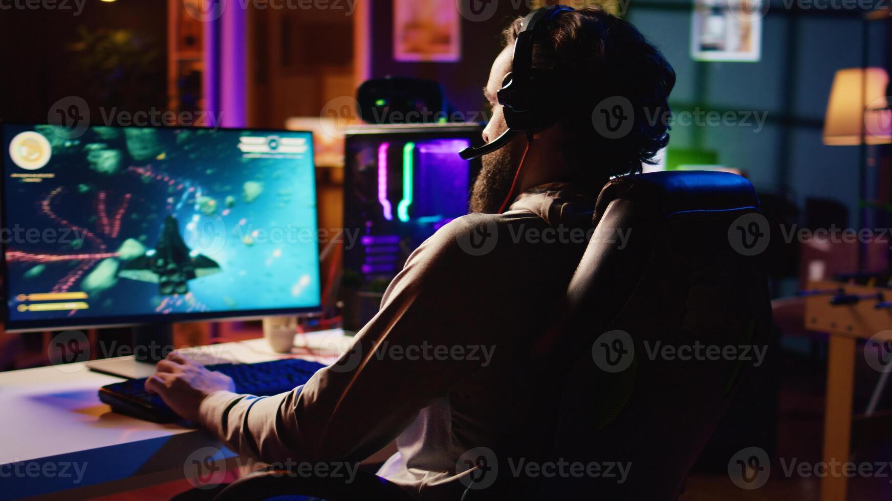 Man at home playing singleplayer videogame with spaceship shooting laser beams at asteroids, panning shot. Pro gamer destroying enemies in science fiction game using gaming mouse photo
