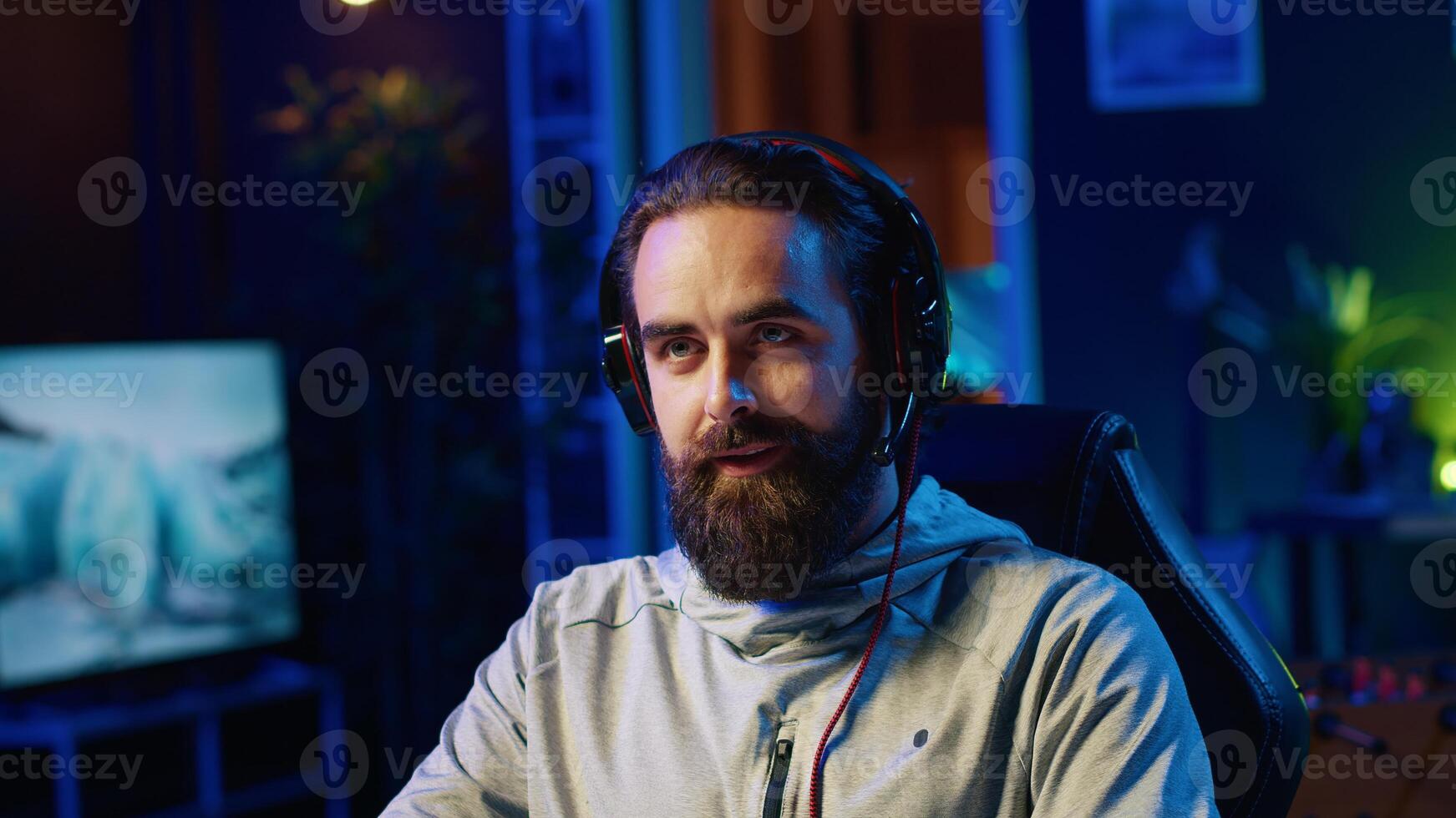 Streamer in studio playing videogames, streaming for online viewers, talking with them about upcoming esports competition. Pro gamer broadcasting gameplay in front of internet audience photo