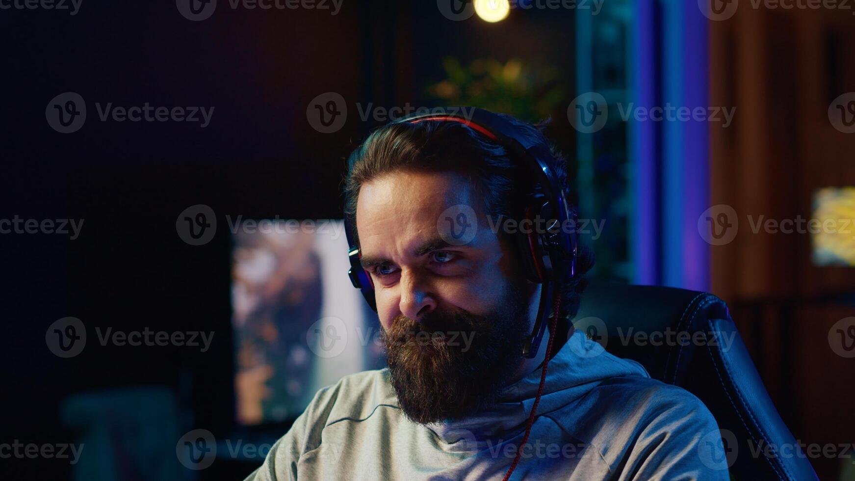 Upset gamer yelling and smashing table after losing online competitive multiplayer match, playing on gaming setup. Close up of man feeling angry and shouting after being defeated in videogames photo