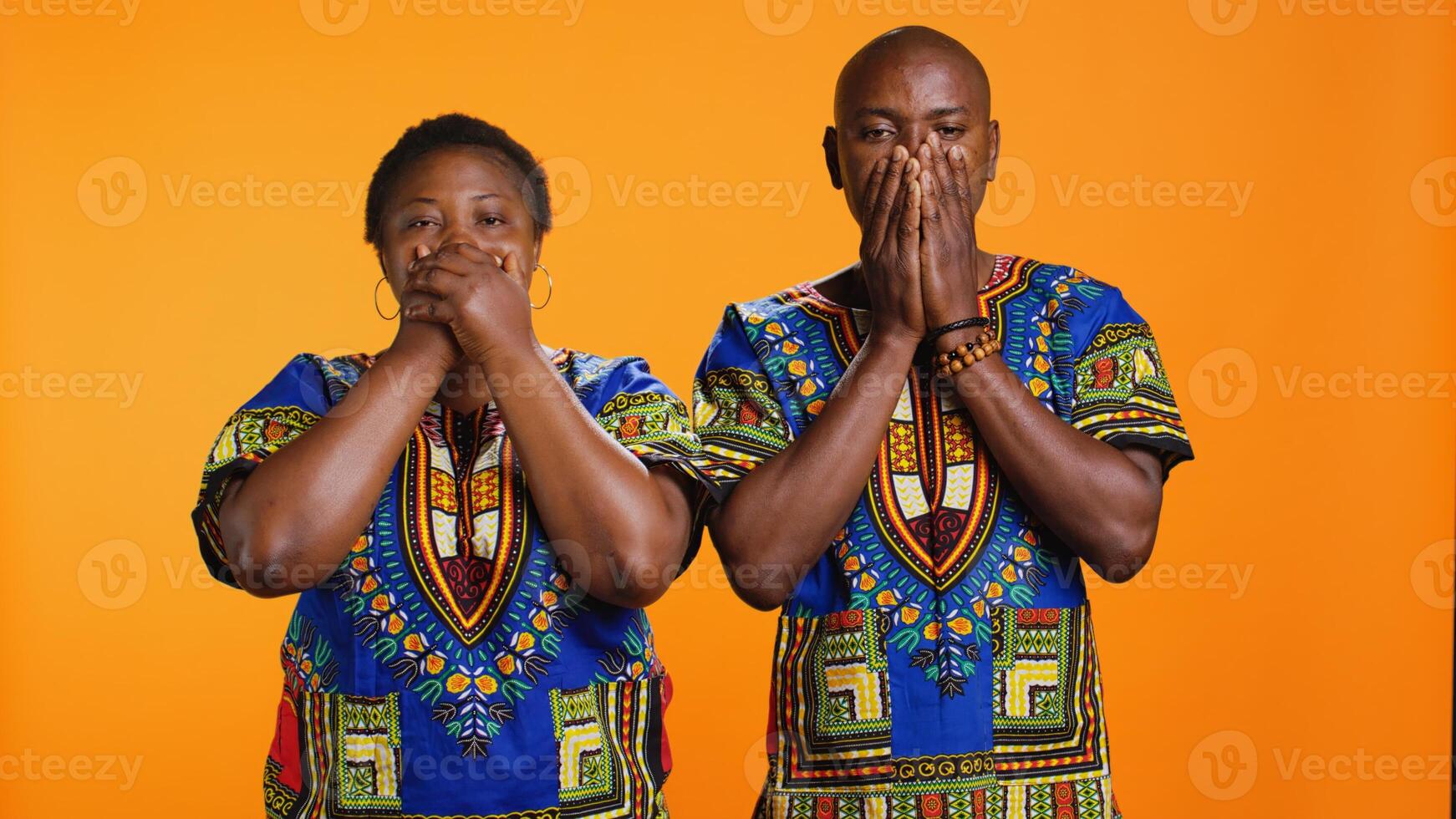 African american people doing three wise monkeys sign, covering their eyes, mouth and ears. Ethnic married couple advertising symbol to dont hear, speak or see bad evil things. photo