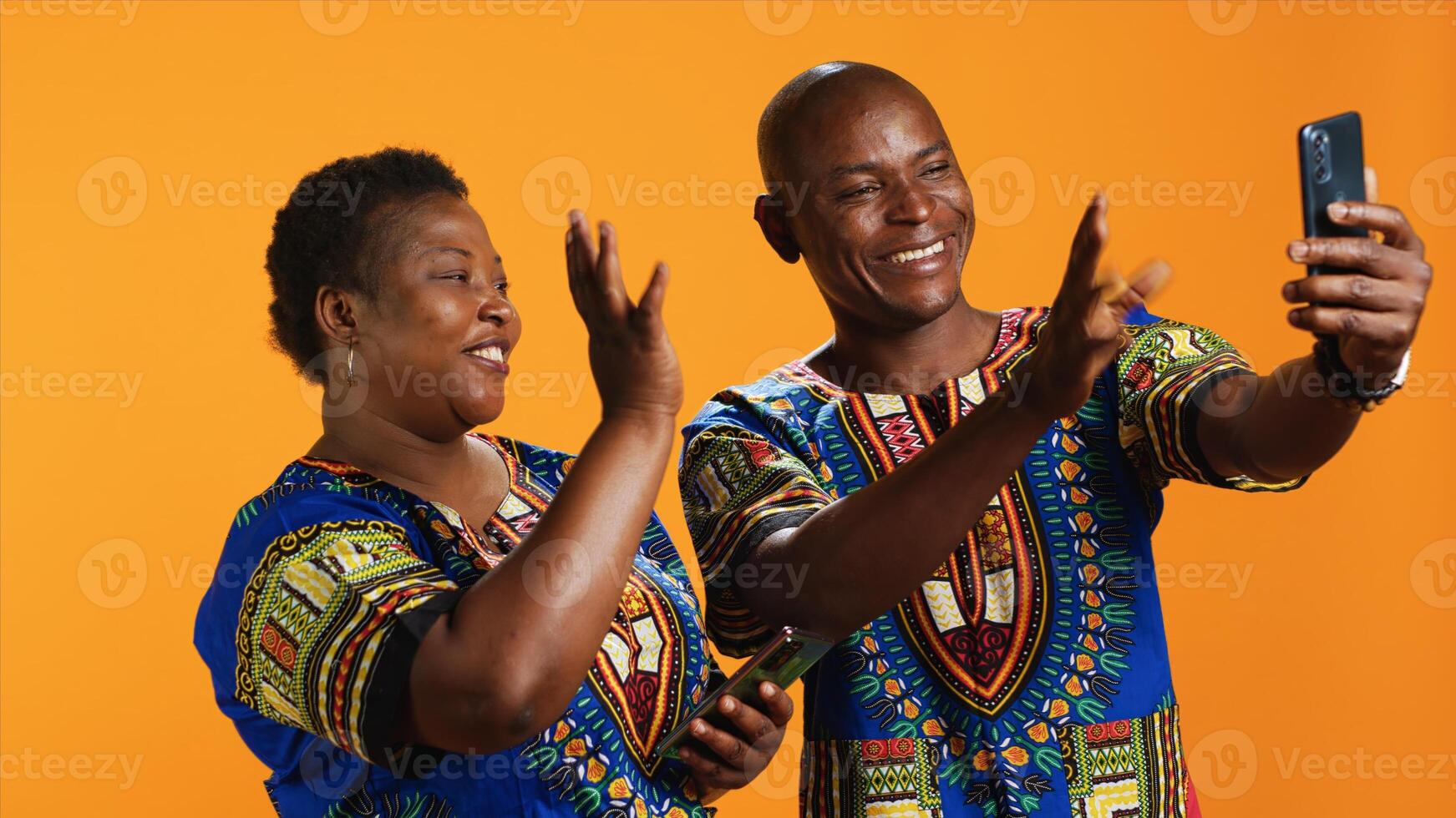 Ethnic couple discussing on videocall connection, meeting with family on internet network. African american man and woman using smartphone app to talk to people on teleconference call. photo