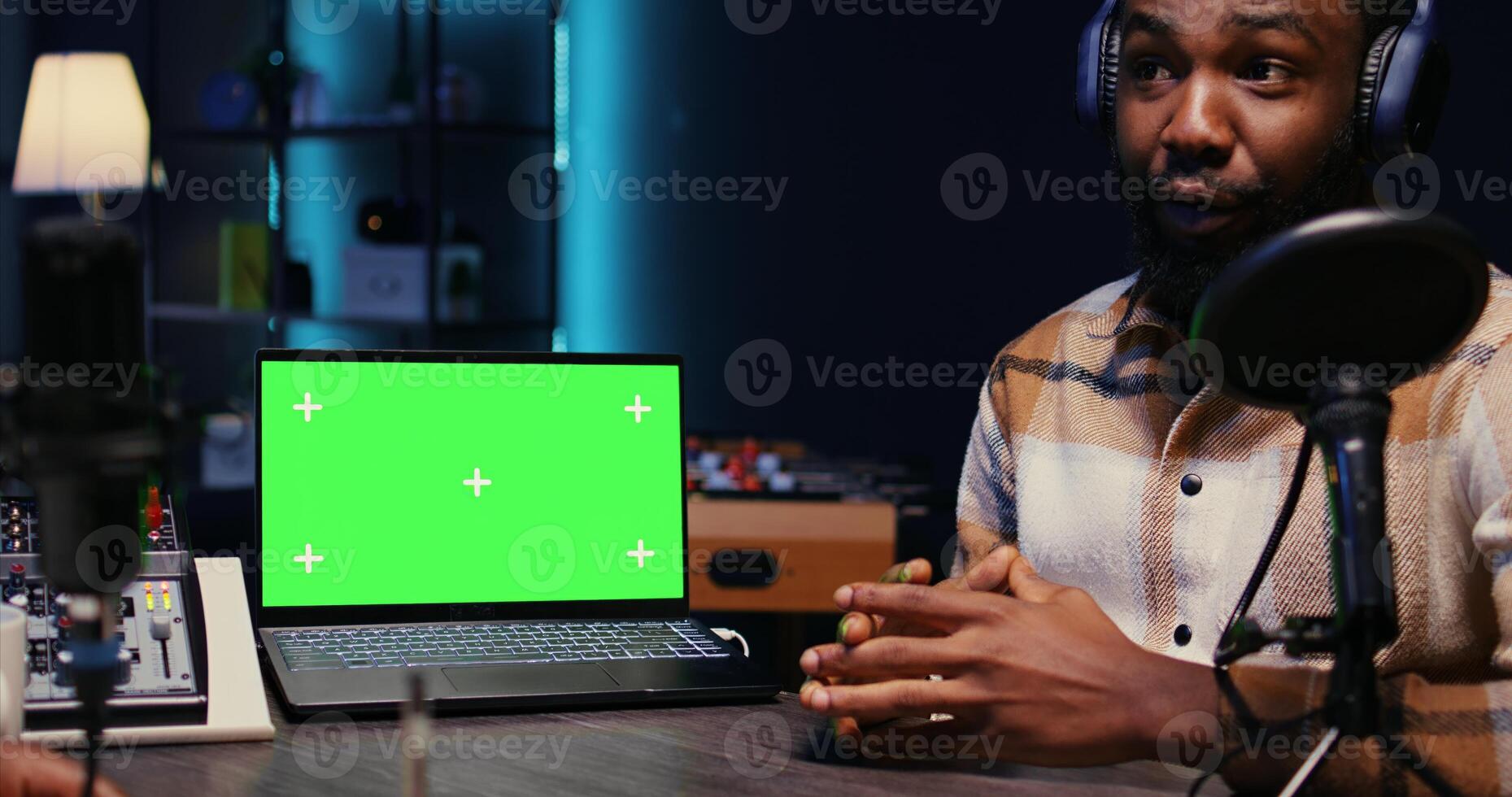Chroma key laptop next to online show host listening to guest opinion on current events during stream for social media platforms. Isolated screen notebook near influencer using recording podcast photo