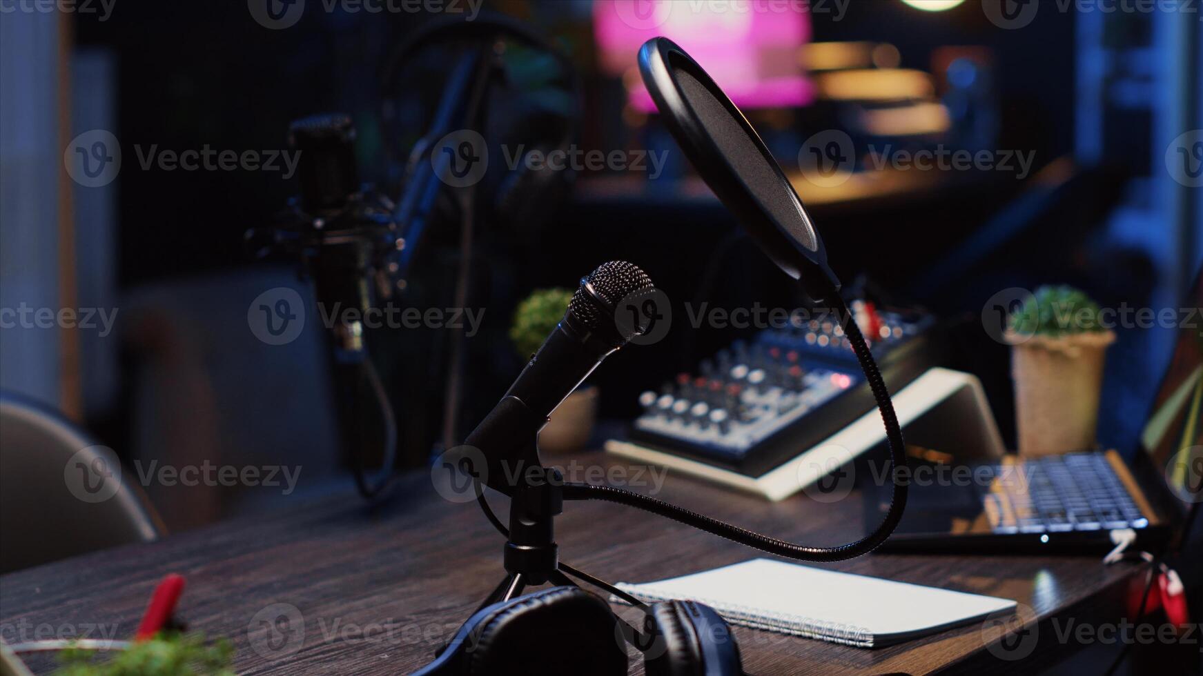 Close up shot of specialized radio microphone used in home personal studio by dj to record internet show guests. Professional audio devices in empty living room used for producing internet show photo