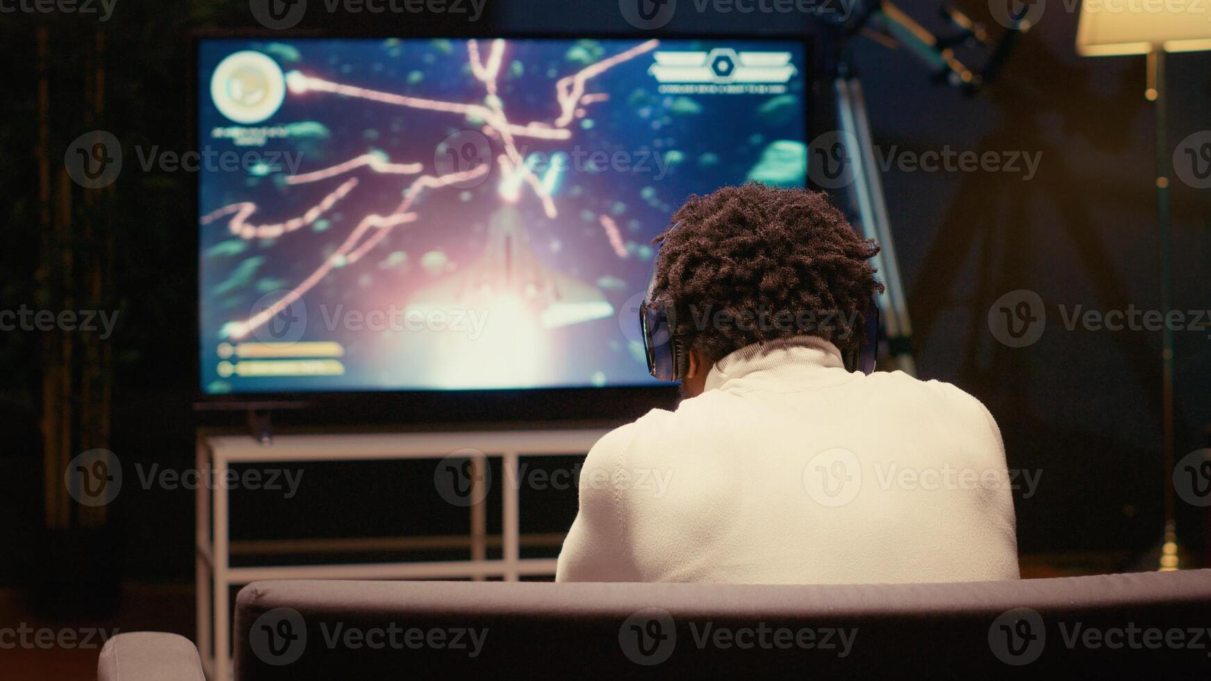 Gamer receiving game over screen on television set, getting his spaceship destroyed in huge explosion while fighting enemies. African american player losing science fiction spacecraft videogame photo